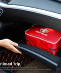 Red compact waterproof first aid kit inside car glove box; side view