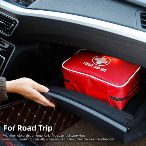 Red compact waterproof first aid kit inside car glove box; side view