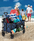 Collapsible Folding Outdoor Utility Wagon with oversized bed, 150 lb load, blue, on beach with gear, cup holders, pocket storage