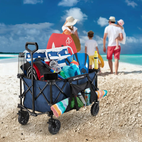 Collapsible Folding Outdoor Utility Wagon with oversized bed, 150 lb load, blue, on beach with gear, cup holders, pocket storage