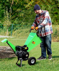 Man operating 7HP Gas Powered Wood Chipper With Three Inch Max Cutting Diameter All Steel Construction Beast Mode Heavy Duty Shredder Mulcher