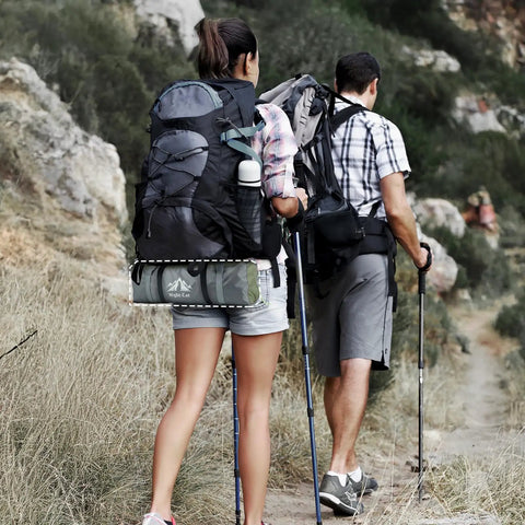 Hikers carrying 2 Person Backpacking Tent Waterproof Lightweight Camping Tent For Two People Hiking Outdoor Mountain With Aluminum Poles Rainfly Army Green Fast Setup Easy Pitch Ultralight Durable on a trail.