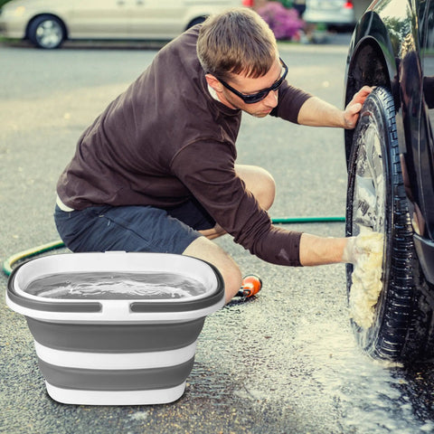 Person washing car with Collapsible 16L Mop Bucket, BPA Free Silicone And PP, heavy duty for portable cleaning