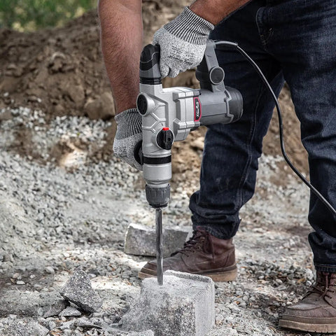 Beast 1200W Electric Rotary Hammer SDS Plus Drill With Swivel Handle in use for concrete drilling on construction site.