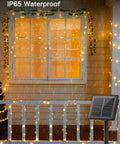 Two Pack Outdoor Solar String Lights 66 Ft Total With 200 LED Warm White Fairy Lights, 8 Lighting Modes, Waterproof shown in rain