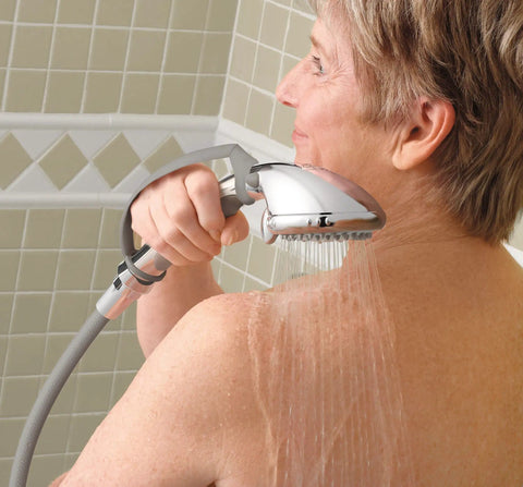 Person using Multi-Function Handheld Showerhead With Non-Positive Pause Control, Chrome Finish, 7-Foot Hose, in tiled shower.