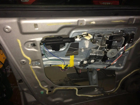 Inside view of Heavy Duty Universal Car Power Door Lock Kit featuring actuators and mounting components for easy installation.