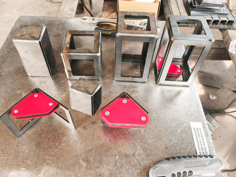 Beginner Welding Practice Kit With Magnets And Coupons, 42 Piece Set Featuring steel plates and magnets on metal table