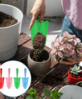 Person using green shovel from 20 Pack Mini Colorful Metal Hand Shovels And Trowels Set For Transplanting And Garden Digging, 11 By 3 Inch Shovels