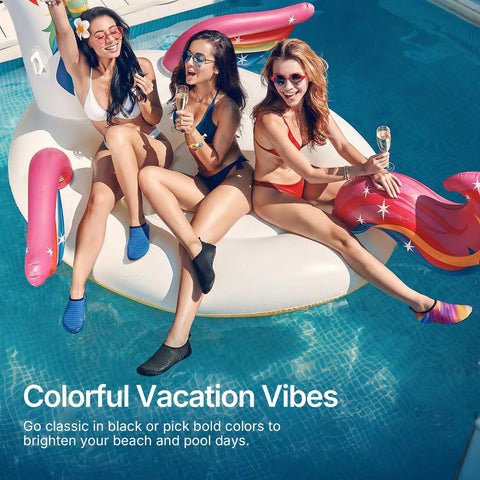 Three women wearing Unisex Water Socks For Beach, Kayak, Pool And Travel, lounging on an inflatable in a pool.