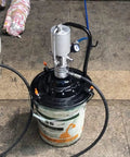 Portable 5 Gallon High Pressure Pneumatic Grease Pump Kit with follower plate on pavement
