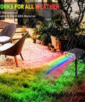 Outdoor Solar Spotlight Kit 4 Pack With 38 LEDs, Color Changing RGB Lights illuminating garden with chairs, IP65 waterproof
