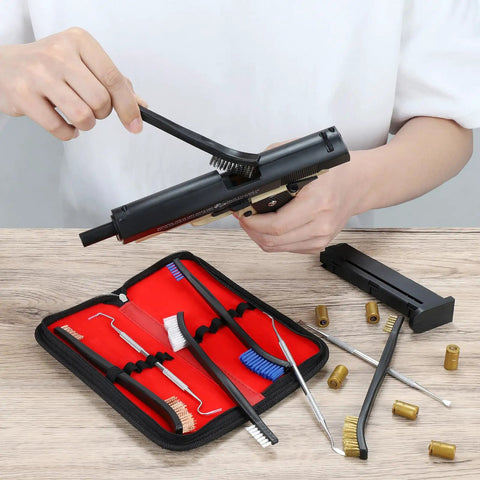 Using Beast Mode Gun Cleaning Kit with double-ended bristle brushes and stainless steel picks on pistol, with 9 piece set visible