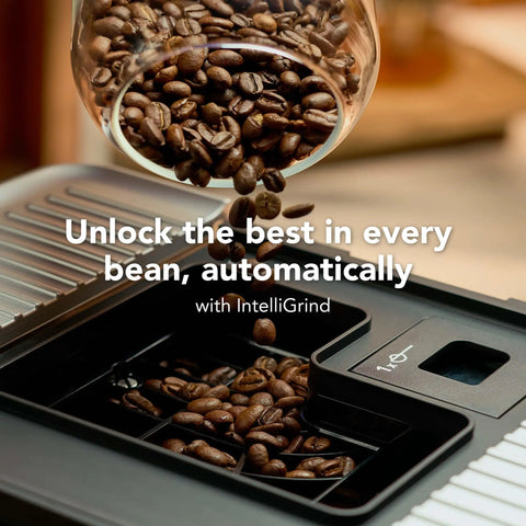 Compact Fully Automatic Espresso And Iced Coffee Maker With One Touch Brewing High Pressure Pump And Rapid Milk Frother For Butter Smooth Lattes That Hit The Spot featuring coffee beans being poured into built-in grinder.