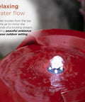 Close-up of the LED glow and water flow on 33 Inch Outdoor Vintage Cascading Antique Jar Water Fountain With LED Lights Red Finish For Garden, Patio And Yard Decor, Soothing Water Flow And Ambient Glow To Elevate Your Outdoor Space And Create A Chill Vibe.