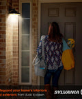 Person entering home at night with Auto On Off Dusk To Dawn A19 LED Bulb With Light Sensor, 60W Equivalent, 800 Lumens, 2700K Soft White.