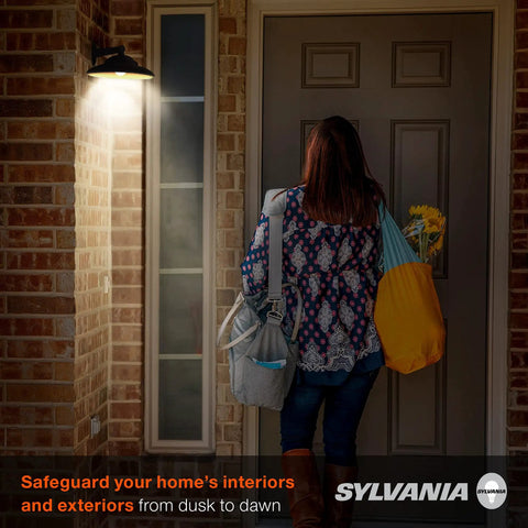 Person entering home at night with Auto On Off Dusk To Dawn A19 LED Bulb With Light Sensor, 60W Equivalent, 800 Lumens, 2700K Soft White.