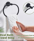 Killer Matte Black Oval Towel Ring Features Smooth Swivel Action Wall Mounted Bathroom Accessory in use with a white towel.