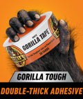 Heavy Duty White Duct Tape 1.88 Inch Wide, 30 Yard Roll Pack Of 2, UV Resistant in a gorilla hand against an orange background