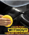 Hand using 4 inch foam applicator pads for car polish on black paint