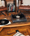 Audio-Technica at-LPGO-BT belt-drive wireless turntable, gun-metal/black, on a wooden coffee table with vinyl records (2).