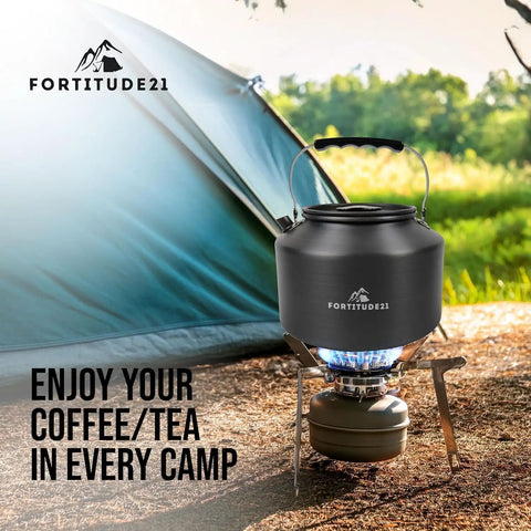 Stovetop Camping Kettle 2.2 Liter Teapot for Boiling Water and Tea Brewing sitting on portable camp stove in front of tent
