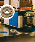 Beefed Up Replacement Gear For Electric Cup Sealing Machines Made From Durable Plastic, Helps Prevent Leaks And Spills, Stable Performance For Beverage Service, Easy Install And Long Lasting Wear, grey gear shown with sealing machine