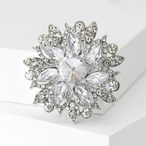 Blue Center Gem Rhinestone Flower Brooch For Women Eight Color Inlay Crystal Pins Jewelry Accessory For Office Party Casual Wear A Luxe Sparkly Statement Piece That Elevates Any Outfit And Makes A Great Gift, shown in silver-tone with clear rhinestones arranged in a floral design.