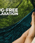Person in hammock under 12ft Lightweight Hammock Bug Net for Camping, Easy Setup, Ultra Breathable 360 Degree Coverage, relaxing with a book