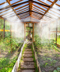 Easy To Use 59-Ft Greenhouse Misting And Drip Irrigation Kit With 1/4-Inch Tubing in use, watering plants inside a greenhouse