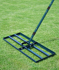 Lawn Leveling Rake With 78 Inch Adjustable Steel Handle in use on grass, showing heavy duty landscape rake for leveling soil, sand, dirt.