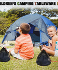 Children sitting by a tent with camping mess kits, featuring Lightweight Four Person Camping Mess Kit With 22 Oz Cup 7.87 Inch Plate