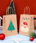 Bulk 150 Pack Brown Kraft Paper Gift Bags With Handles 5.25 x 3.2 x 8 Inches featuring Christmas tree and Santa designs.