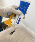 Hands holding Fast Dry Wall Patch Kit With Scraper For Holes And Cracks White Wall Repair Paste Waterproof Heavy Duty