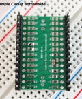 SMD To DIP Breakout PCB Module With SOIC 28 To DIP Adapter, dual row header on breadboard, 28 pin wide, bottom view.