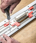 Close-up of No Fuss Adjustable Door Latch And Strike Plate Router Jig featuring precision adjustments and red clamps during setup.