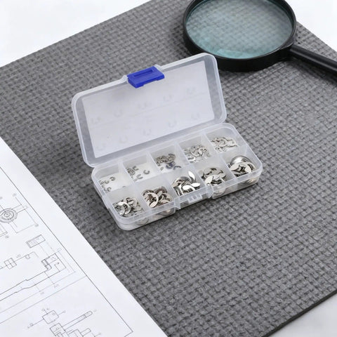 120 Piece E Clip Circlip Assortment Kit With 304 Stainless Steel Retaining Rings, open box on a gray mat with a magnifying glass