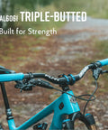 Upturn High Rise Mountain Bike Handlebar 35mm Clamp 800mm Wide 75mm Rise Alloy Riser Bar For MTB And BMX on blue bike in forest