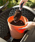 Close-up of Double Bin Rotating Composter With Two 50 Gallon Barrels For Nonstop Composting being filled with soil