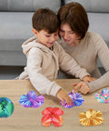Mother and child playing with colorful 3D Printed Gear Sphere Fidget Toy For Sensory Stress Relief And Chill on a wooden table