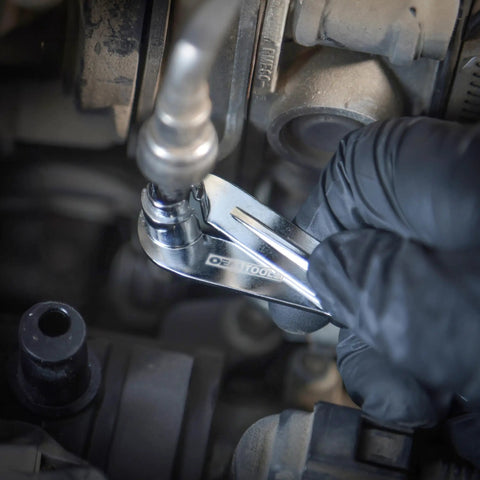 Mechanic using Transmission Line Disconnect Tool For Ford And Cadillac Oil Cooler Lines Three Eighths And One Half Inch Easy Release Step Design For Strong Grip And Durable Metal Construction on car engine