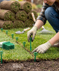 Person installing 200 Pack 4 Inch Biodegradable Landscape Stakes For Landscape Fabric Weed Barrier And Turf Sod Staples on lawn