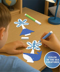 Child using Deep Sea Crystal Grow Kit for Kids - 32-Piece STEM Chemistry Lab to color sea creatures on a desk