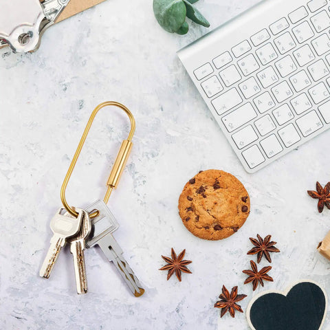 Heavy-Duty Brass Key Ring Clip Set 4 Pcs 3.35in Screw Lock Keychain with keys on desktop next to keyboard and cookie