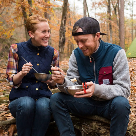 Couple enjoying meal with Stainless Steel Camping Mess Kit With Flexible Straps Space Saving Dish Set For Hiking Backpacking