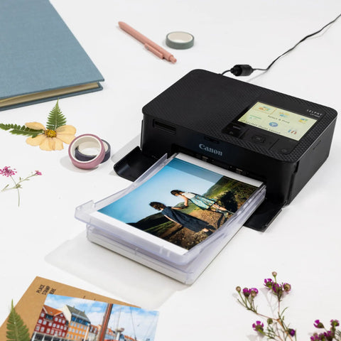 Selphy CP1500 Wireless Photo Printer In Black Ultra Portable Mini Printer With WiFi And Smartphone Connectivity printing a photo