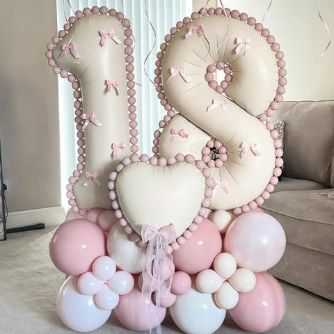 Giant Forty Inch Beige Mylar Foil Number 1 Balloon With Straw For First Birthday And Age Milestone Party Decorations That Are A Straight Up Game Changer, featuring a decorative 18 balloon display with pink accents.