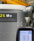 Close-up of 600 ft One Eighth Inch T316 Stainless Steel Aircraft Cable with digital measurement tool in warehouse.
