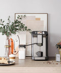 Level Up Your Daily Grind With This Fully Automatic Espresso Machine Featuring A Built In Grinder Dual Boiler Heating Premium Milk Frother And Smart Touch Panel For Six Quick Barista Shots In Sleek Gunmetal on a kitchen counter.