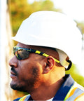 Sick Clear Vision Transition Safety Glasses With Anti Fog Coating And Scratch Resistant Lenses Featuring Adjustable Non Slip Fit For Legit All Day Comfy ANSI Certified Protection worn by a man in a hard hat.